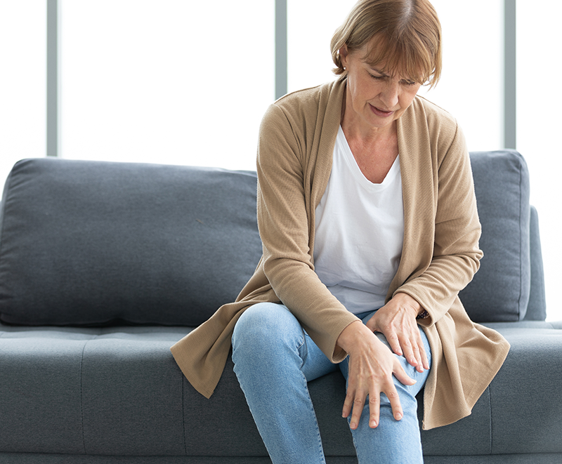 Woman holding her knee